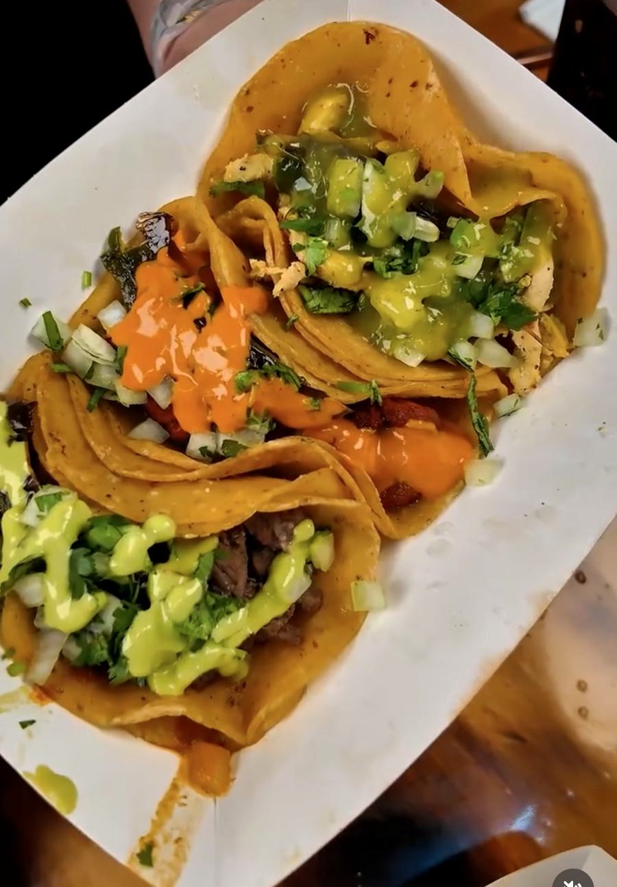 Street tacos with salsa verde and orange salsa, onion and cilantro